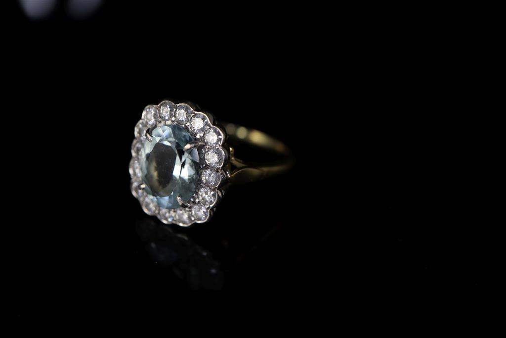 A modern 18ct gold, aquamarine and diamond cluster ring,